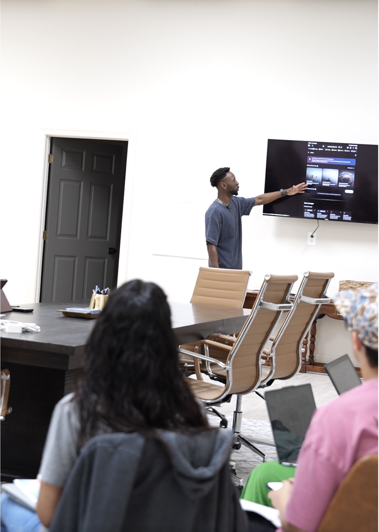 Coach Dom walking attendees through an AI tool on screen during a live workshop