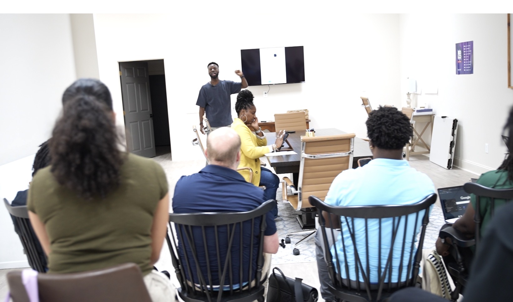 Coach Dom leading an AI workshop for a room of business professionals